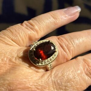 Red stone Ring stamped 925. New and beautiful. Halo with white crystals. Size 7